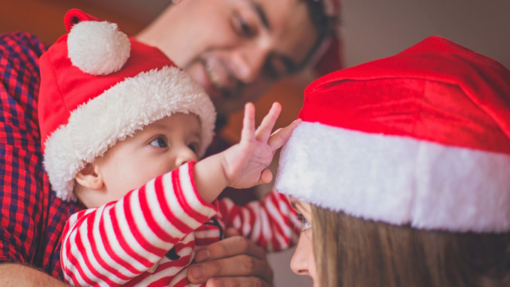 Family-dressed-in-Santa-Hats-Baby's-First-Christmas