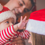 Family-dressed-in-Santa-Hats-Baby's-First-Christmas